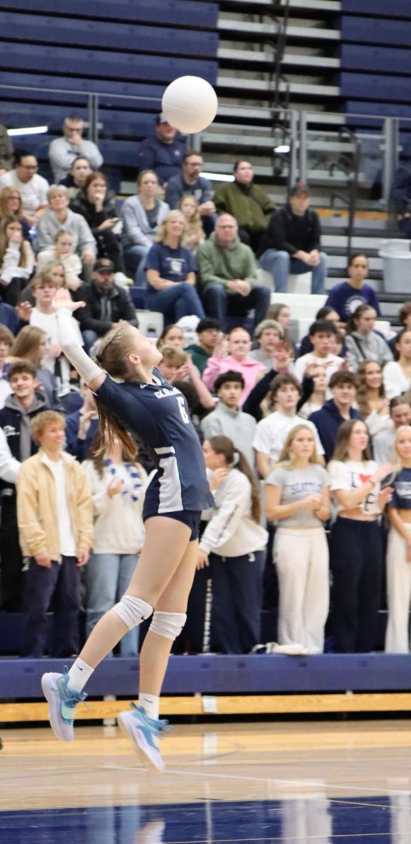 Marcy Mossburgs prepares to serve the ball during the varsity volleyball game against Mount Si.