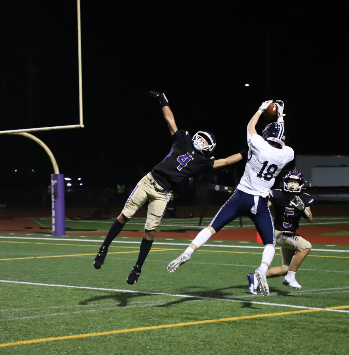 Zachary Albright snatches the ball out of his opponent's way during the varsity football game against Lake Stevens.