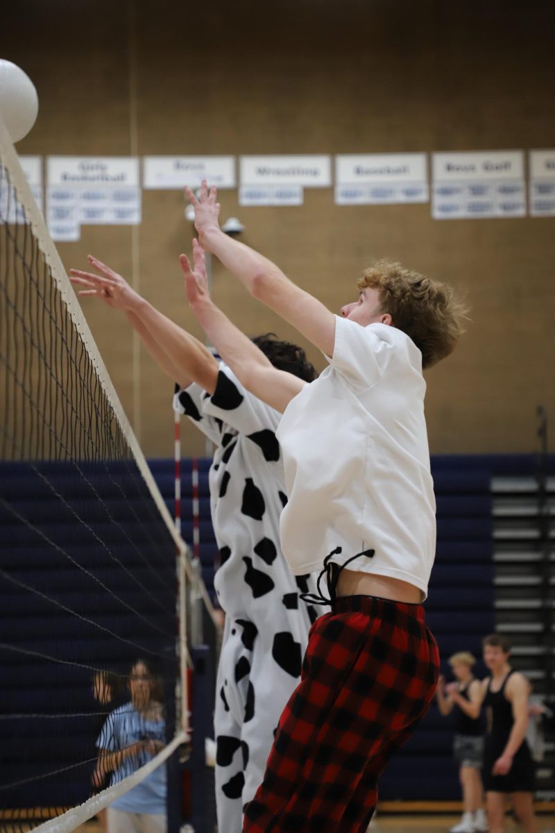 Benjamin Starr and Sydric Cheng defend their side of the court by blocking the other teams spike during Macho Volleyball.